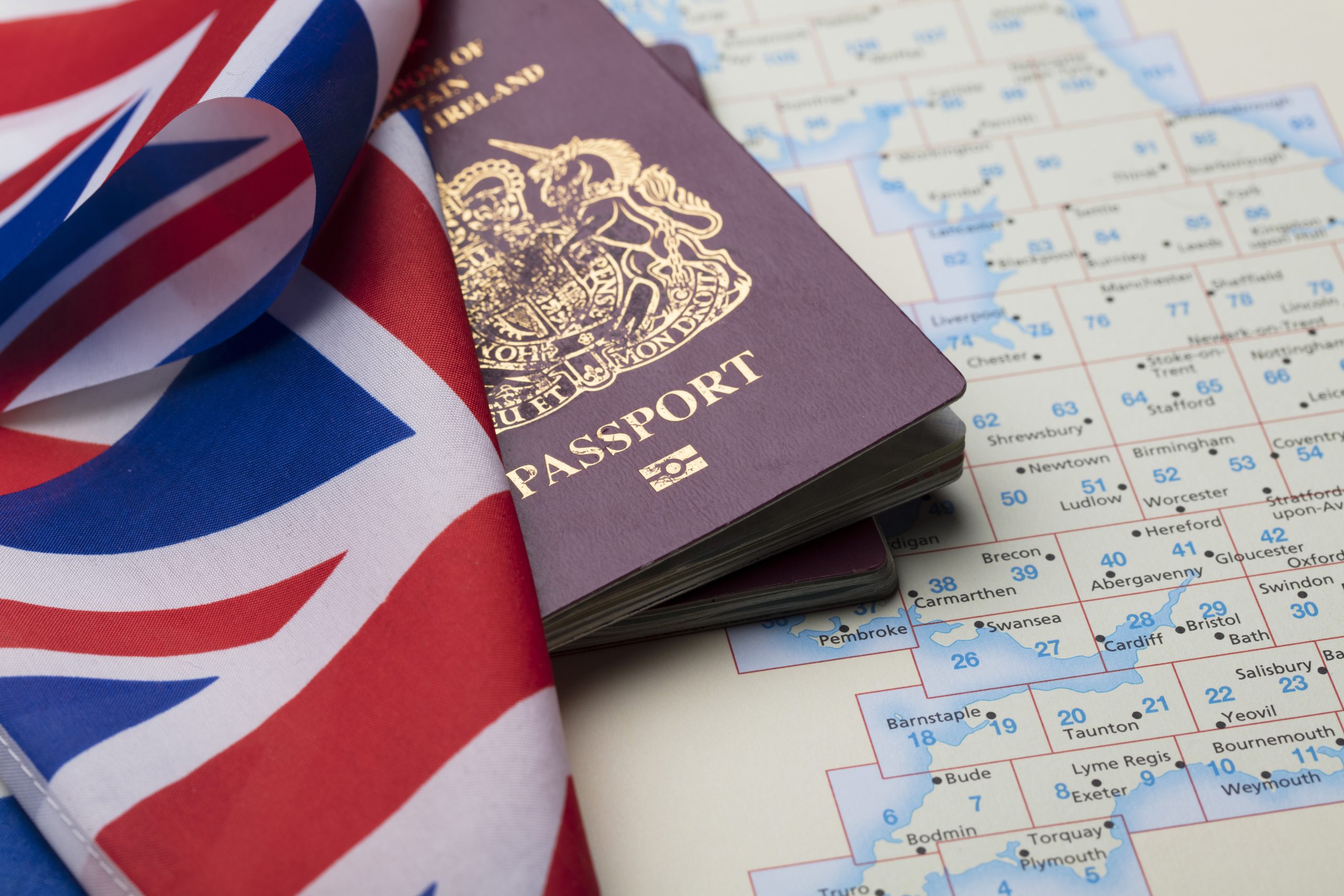 united kingdom passport with union jack flag map
